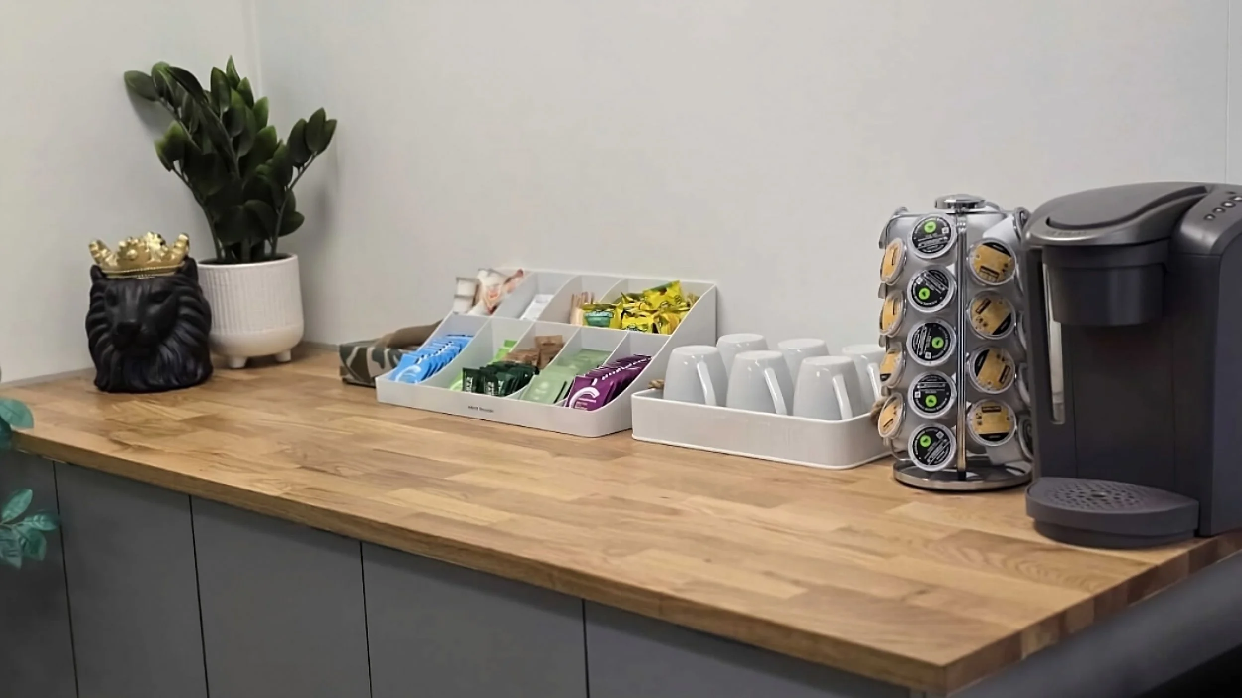 Free coffee, tea, and snack bar with decor in reception area at Embark Psychology Calgary clinic
