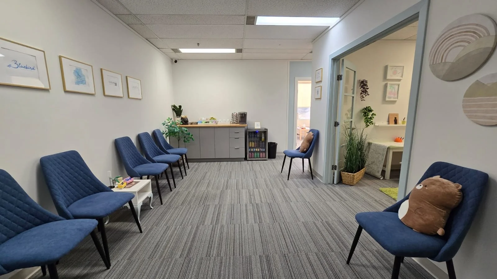 Large reception area at Embark Psychology Calgary clinic with soft seating, warm lighting, cute decor, and full amenities 