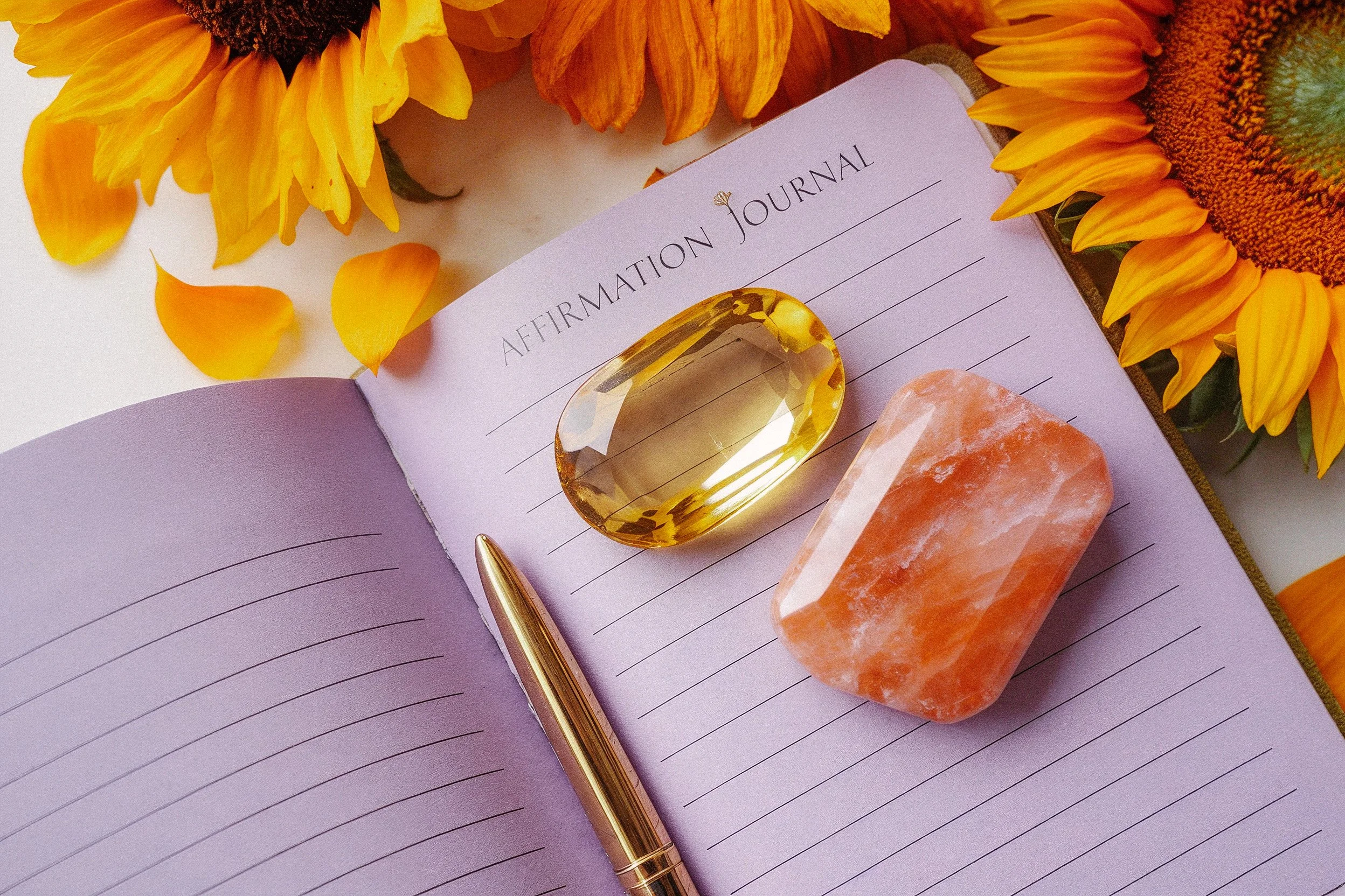 Spiritual journal with citrine crystals and sunflowers for intuitive coaching, clarity, and soul awakening session