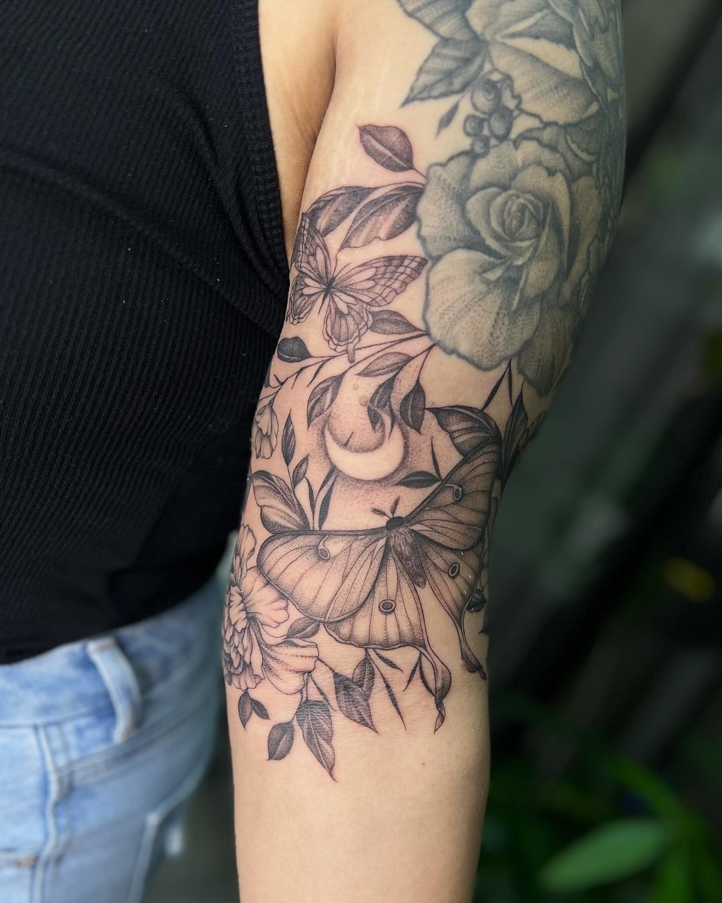 We finished off her upper half sleeve with a Luna moth and whimsical garden (existing work not done by me). Her last name is Luna so the moon and moth was a special touch for her❣️

Now booking for July-August. Use the link in my bio to my website to