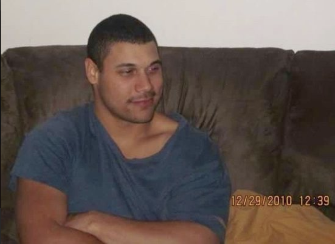 Neil Harris, Jr. sits on a couch in a 2010 family photo.