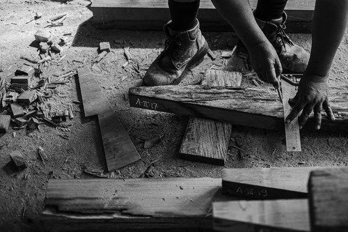 Craftsperson preparing structural timber joinery on a reclaimed Ulin beam
