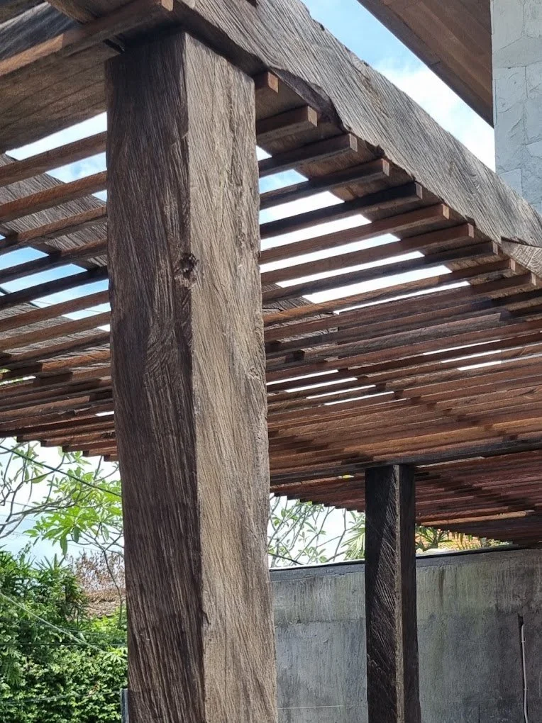 Rustic reclaimed Ulin beams supporting architectural timber screening