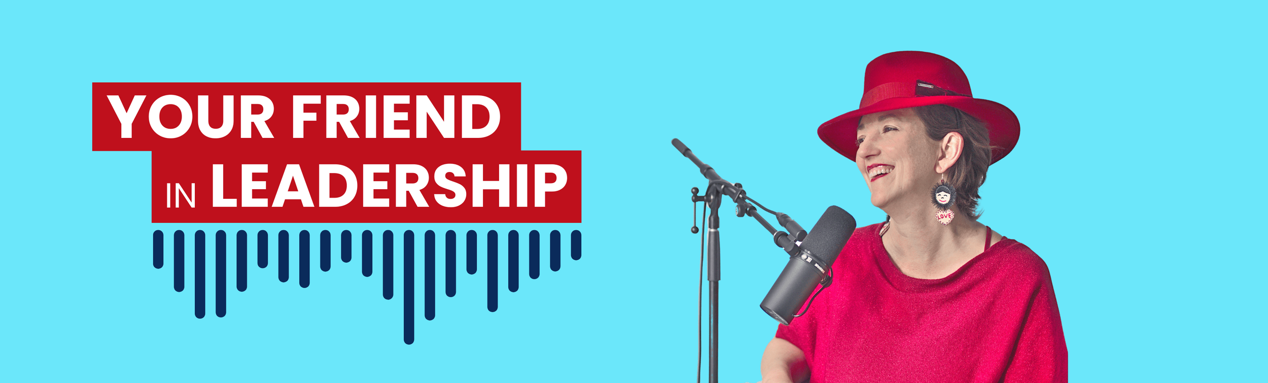 Woman smiling in a red hat and red top, speaking into a microphone with a blue background and a sign that says 'Your Friend in Leadership'.