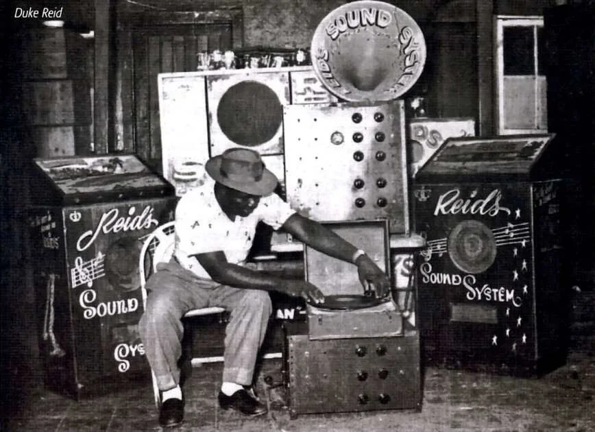 "Duke Reid seated in front of his legendary Trojan sound system, Kingston Jamaica, 1950s"