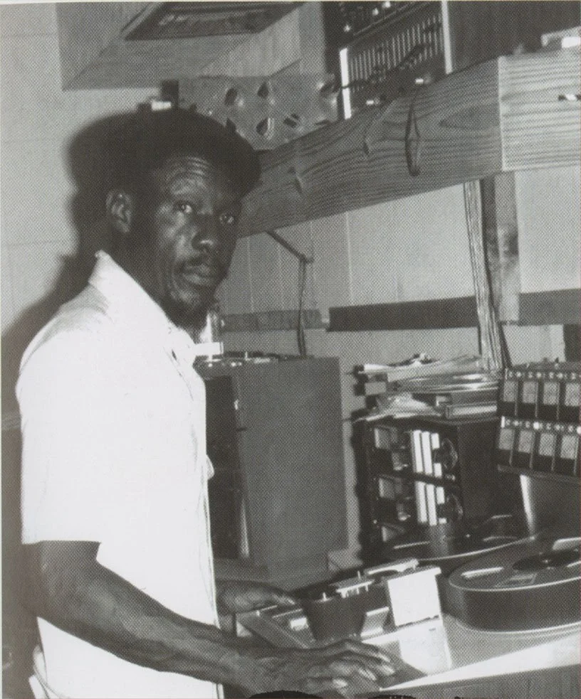 Black and white portrait of Duke Reid standing in a recording studio