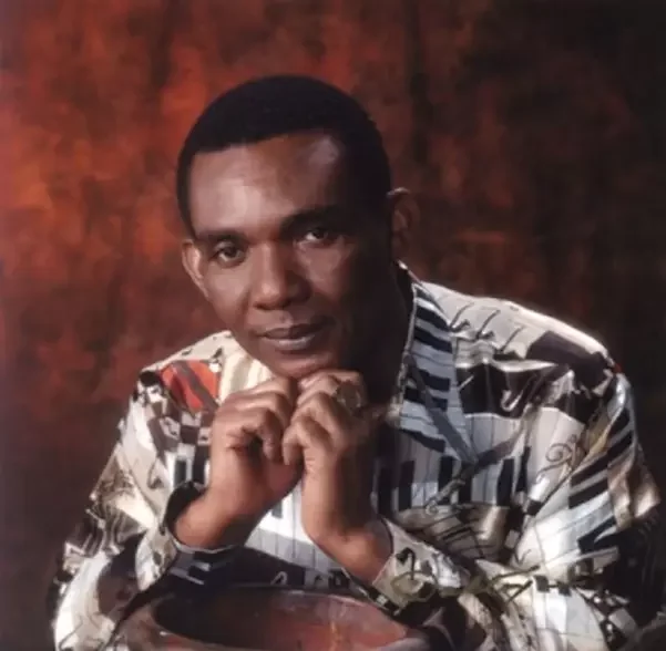 Ken Boothe seated on a chair.