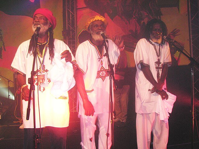 Colour photo of the Jamaican reggae group The Congos, showcasing the band members together, representing their  representing their contribution to roots reggae and vocal harmony traditions.