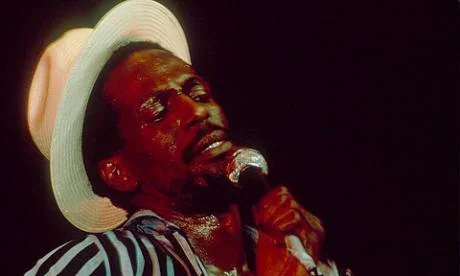 Close up of Gregory Issacs live on stage.