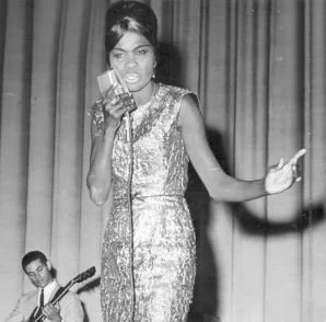 Black and white portrait of Hortense Ellis holding a microphone, Jamaican reggae and rocksteady singer