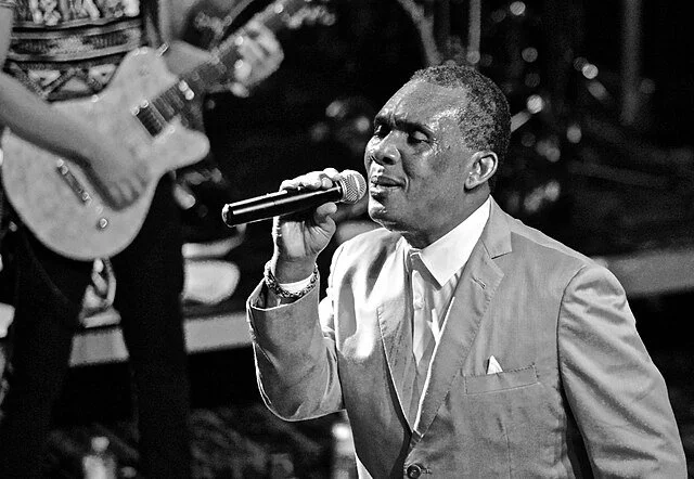 Black-and -white portrait of Ken Boothe, iconic Jamaican singer,highlighting his role in the evolution of ska, rocksteady, and reggae.
