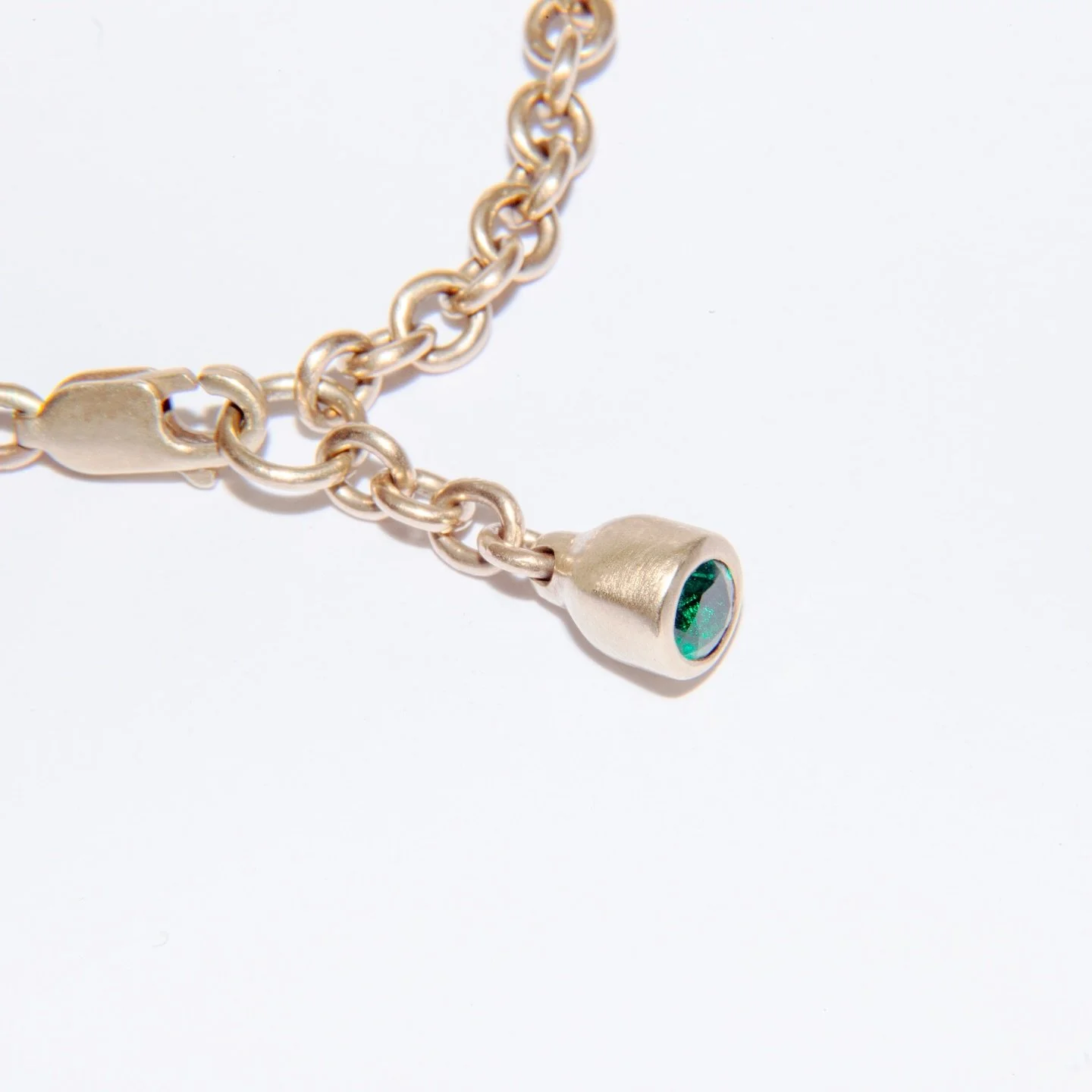 Bell bracelet. Signature trace chain set with your chosen stone, bezel set in a gold bell.