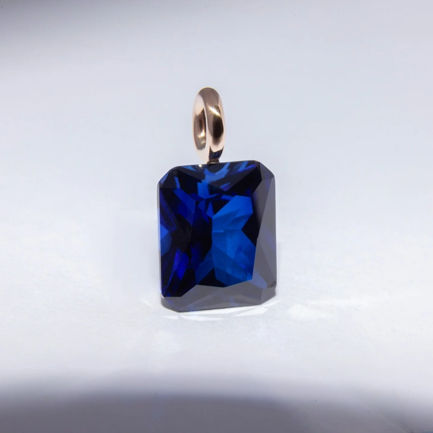 This client came to me with a unique challenge, a sapphire pendant with no claws or bezel.

Through specialized lapidary work, we engineered a solution where the stone is supported entirely by the bail. No metal to obstruct the light, just a radiant 