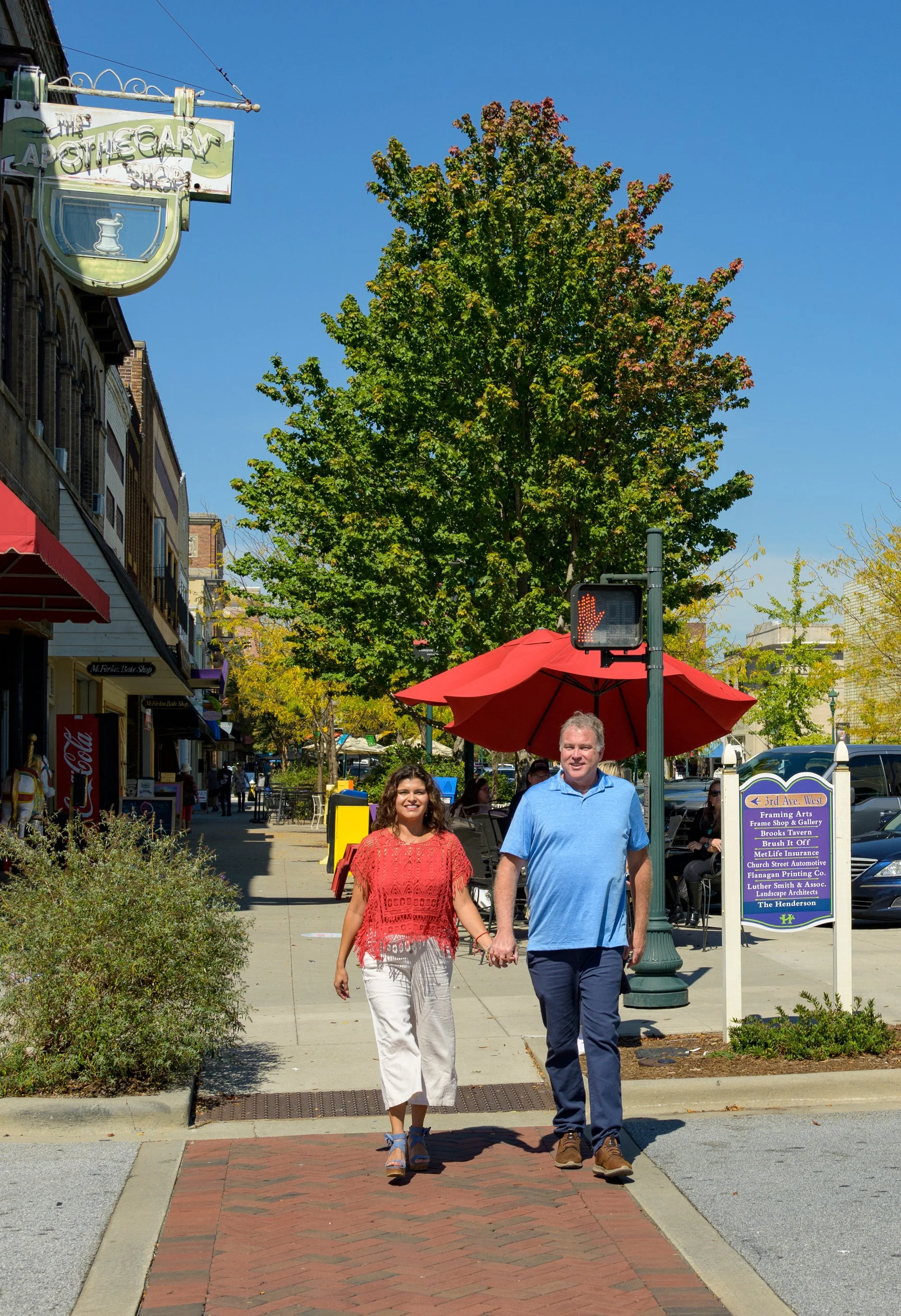 Couple walking down mainstreet Hendersonville NC