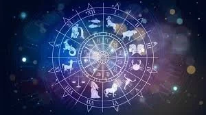 An astrological chart with zodiac symbols arranged in a circle against a cosmic background of stars and nebulae.