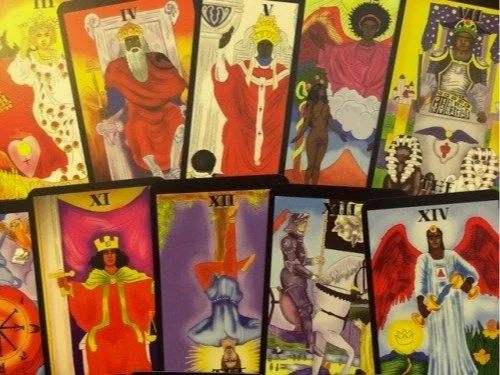 A spread of colorful tarot cards, featuring various figures and symbols from the Major Arcana, including the Empress, Emperor, Hierophant, and Justice cards.