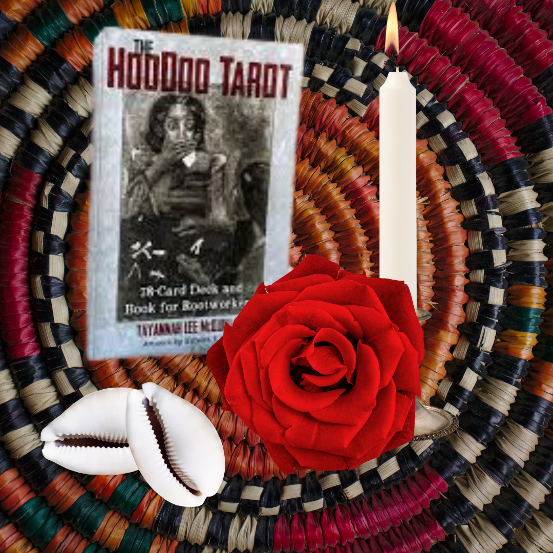 A decorative arrangement with a book titled 'The HooDoo Tarot', a red rose, a white candle, a cowrie shell, and a card with Chinese characters, all placed on a woven circular mat with multicolored strands.