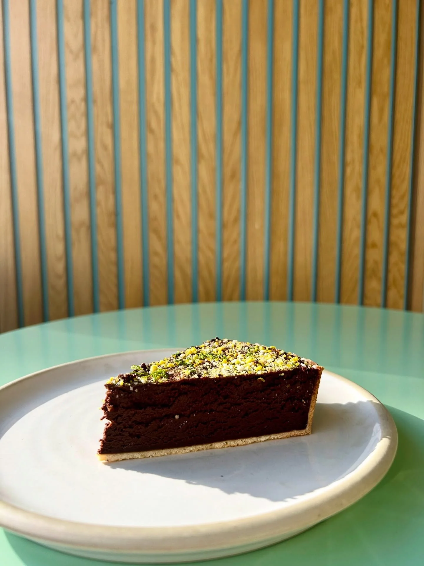 Baked chocolate mousse tart w/ pistachio &amp; lime.

Working its angles. 📸.