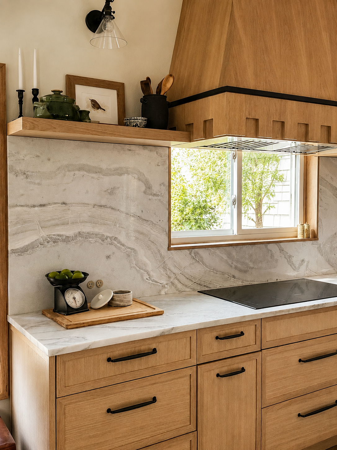 Kitchen with wooden cabinets, marble countertop, a black kitchen scale with green apples, a window with outside greenery, and shelves with decorative items and kitchen utensils.