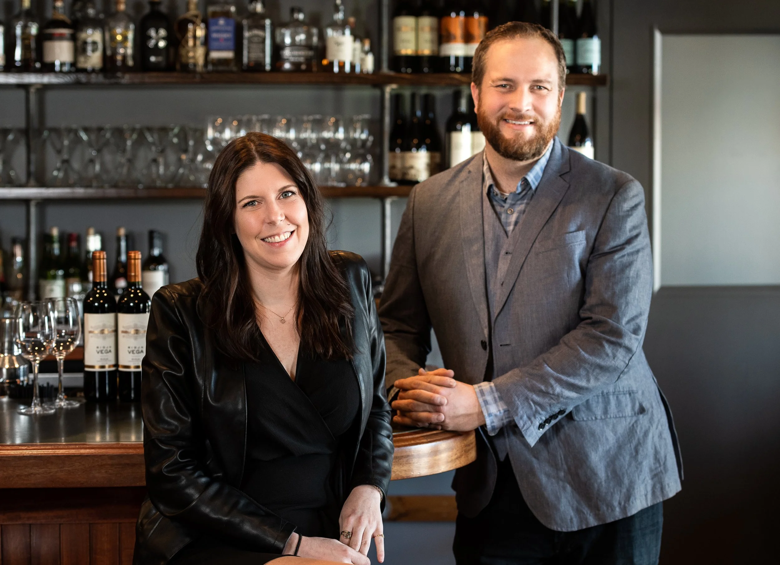 Owner's Tierney and Tyler posing in a bar setting
