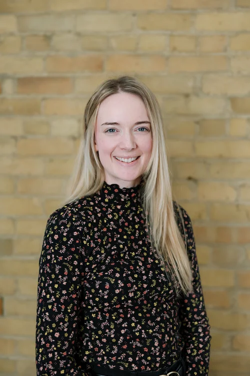 Kaitlyn Conner, with long blonde hair and a floral blouse.