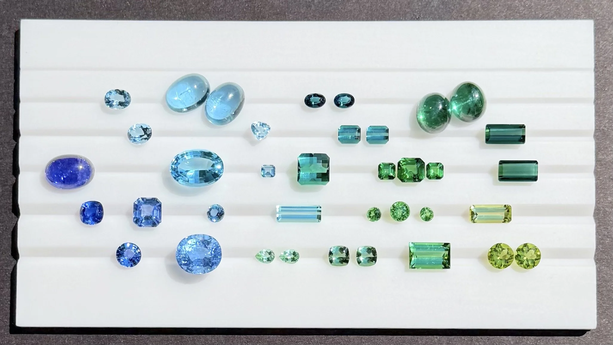 Drop 1 - blue and green fine gemstones - aquamarine, blue topaz, tourmaline, sapphire, peridot, tanzanite, tsavorite garnet.jpeg