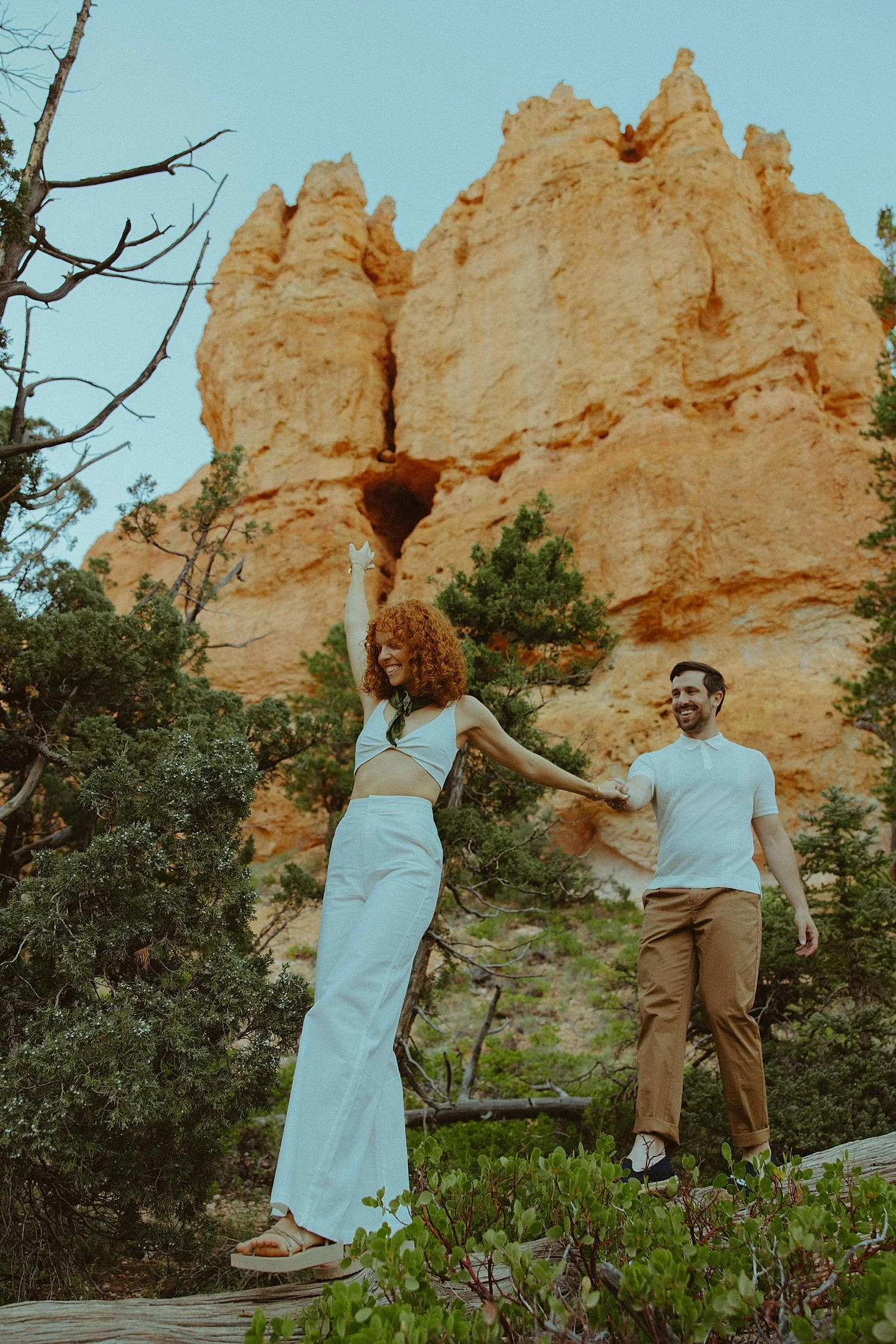 Engaged couple walking in Bryce Canyon National Park