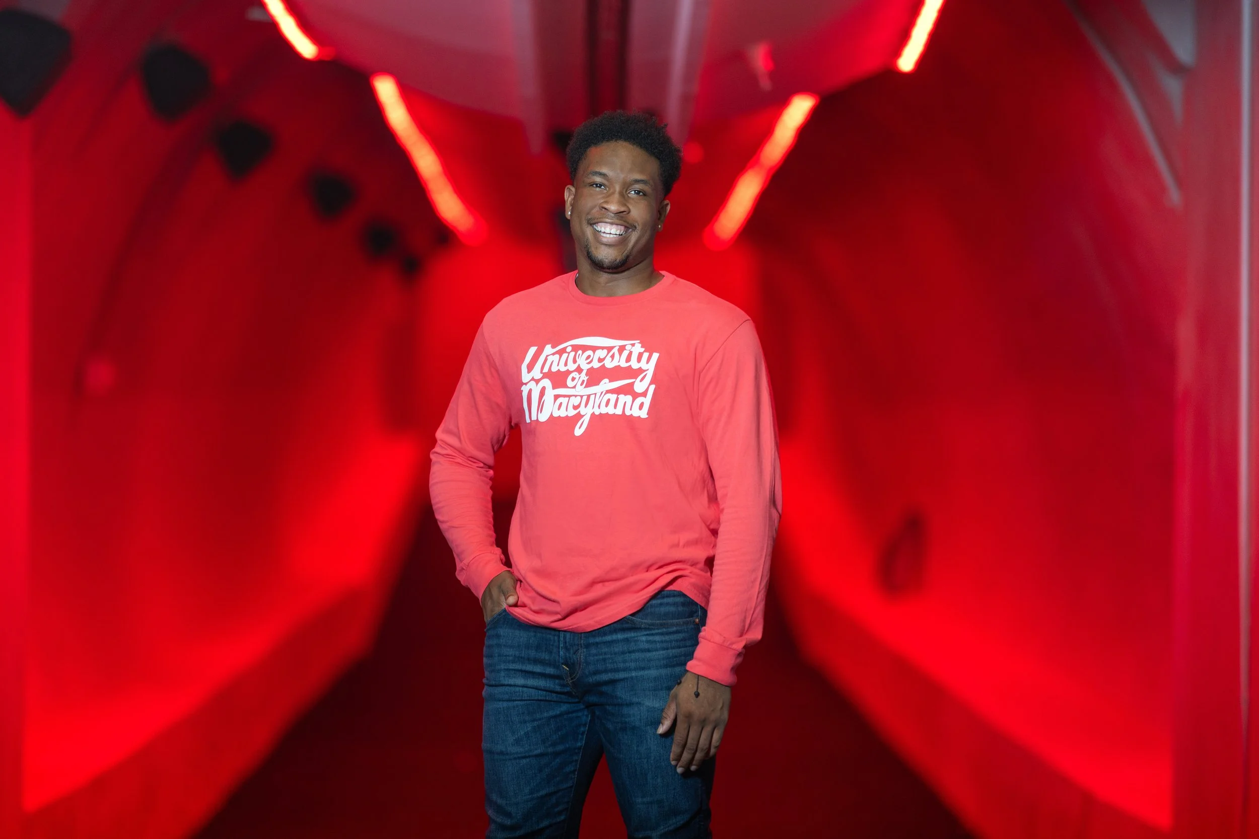 A man giving a presentation at a conference, with a screen behind him displaying the text "Kingdom Advisors Champions Forum New York." Several seated attendees listen, some taking notes, in a modern conference room.