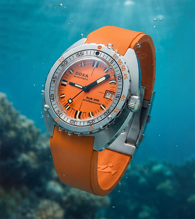 A Doxa SUB 300 professional dive watch with an orange dial and strap, underwater, with bubbles around it.