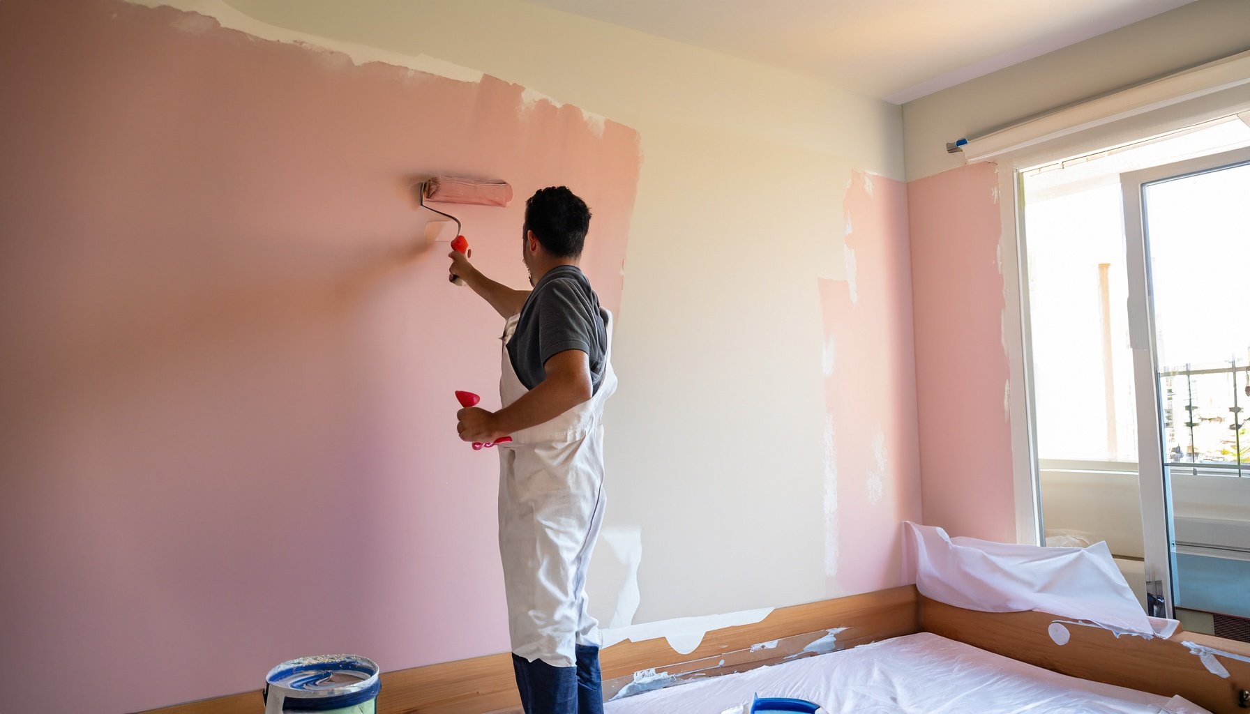 Firefly living room being decorated by a male professional painter wearing all white trousers, using.jpg