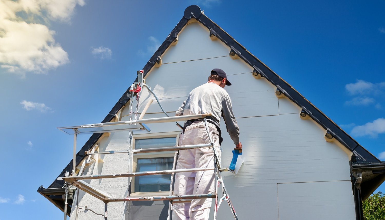Firefly+external+of+a+house+being+painted+magnolia+on+a+metal+chrome+ladder+in+cornwall+by+a+male+de.jpg