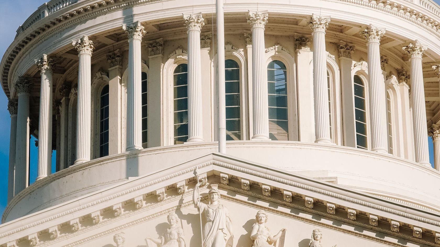 Columned dome of a state capitol building, representing telecom infrastructure projects for government agencies