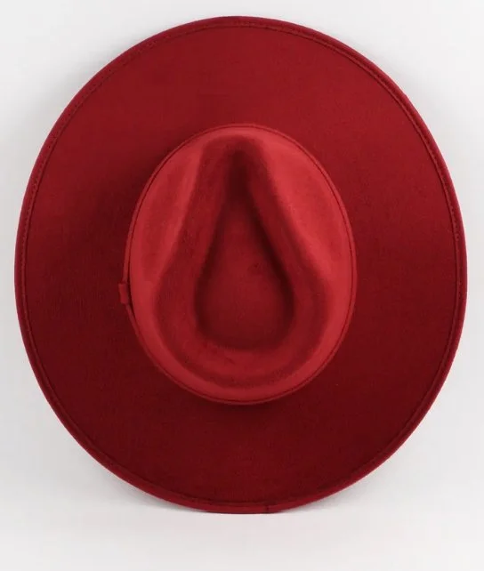 Red cowboy hat viewed from above against a white background.