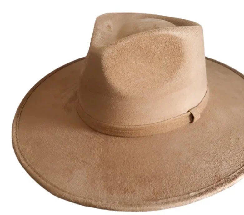 A tan cowboy hat with a wide brim and a pinched crown.