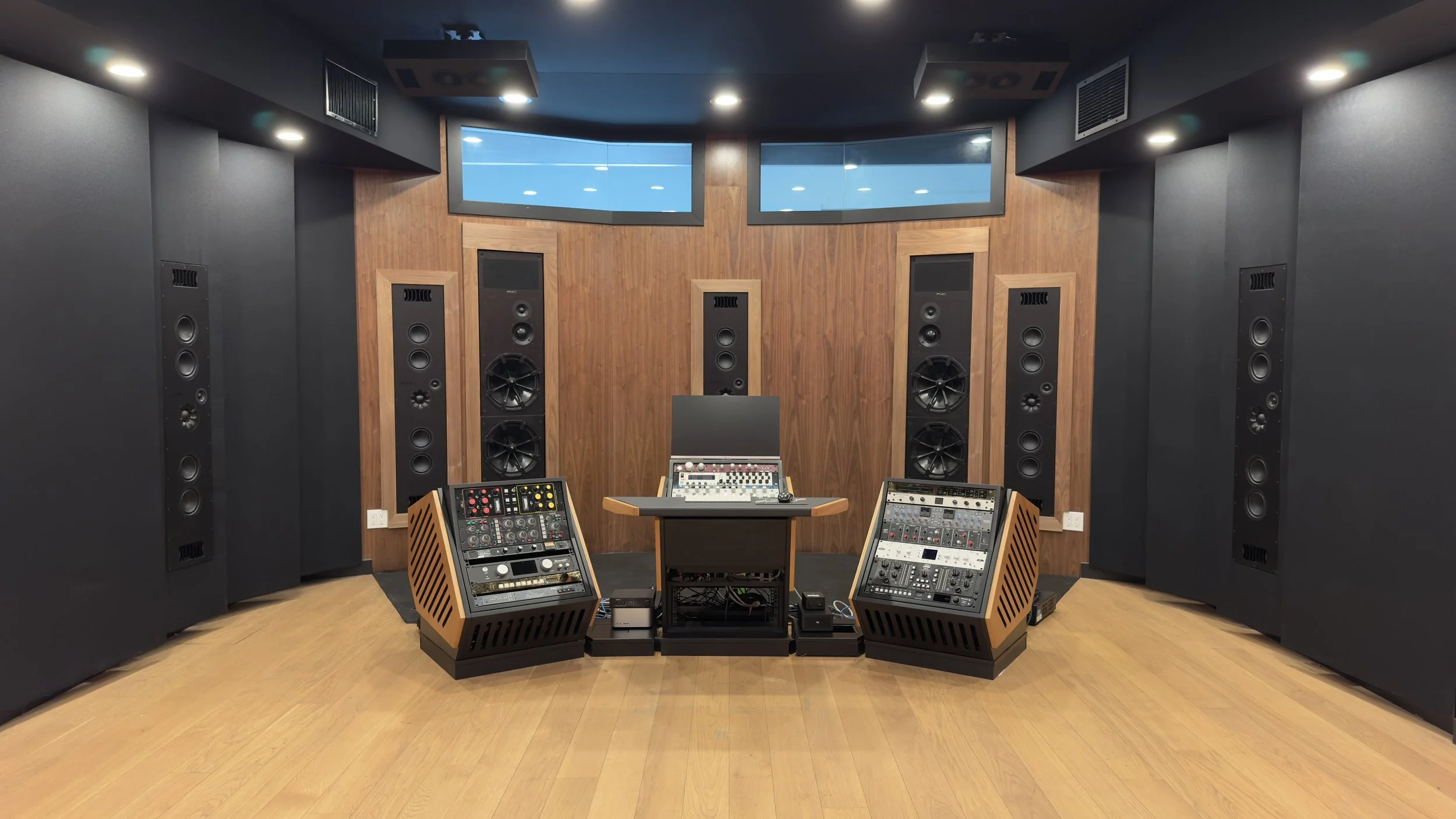 The front wall of the Paris Lee Mastering Atmos studio viewed from the center of the room