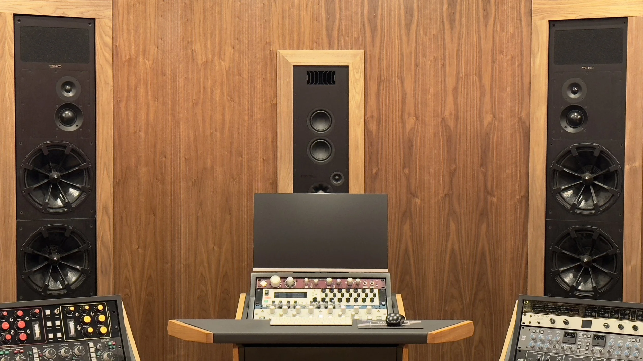 Close up of Paris Lee Mastering atmos studio front wall from mix position