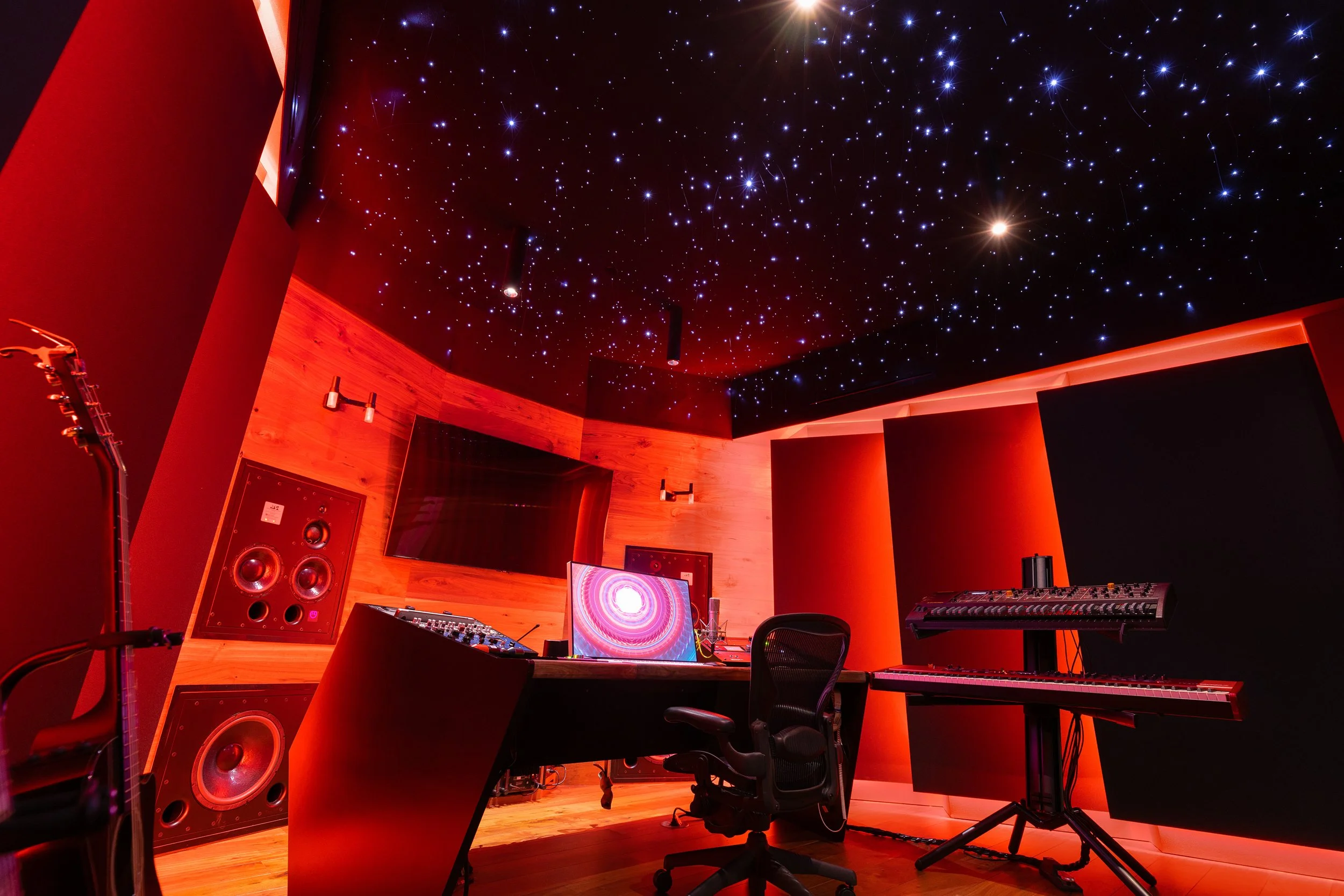 Zedd 1 control room with red lighting and an LED starry sky installation on the ceiling. Low view of front wall that draws attention to starry sky effect on ceiling.