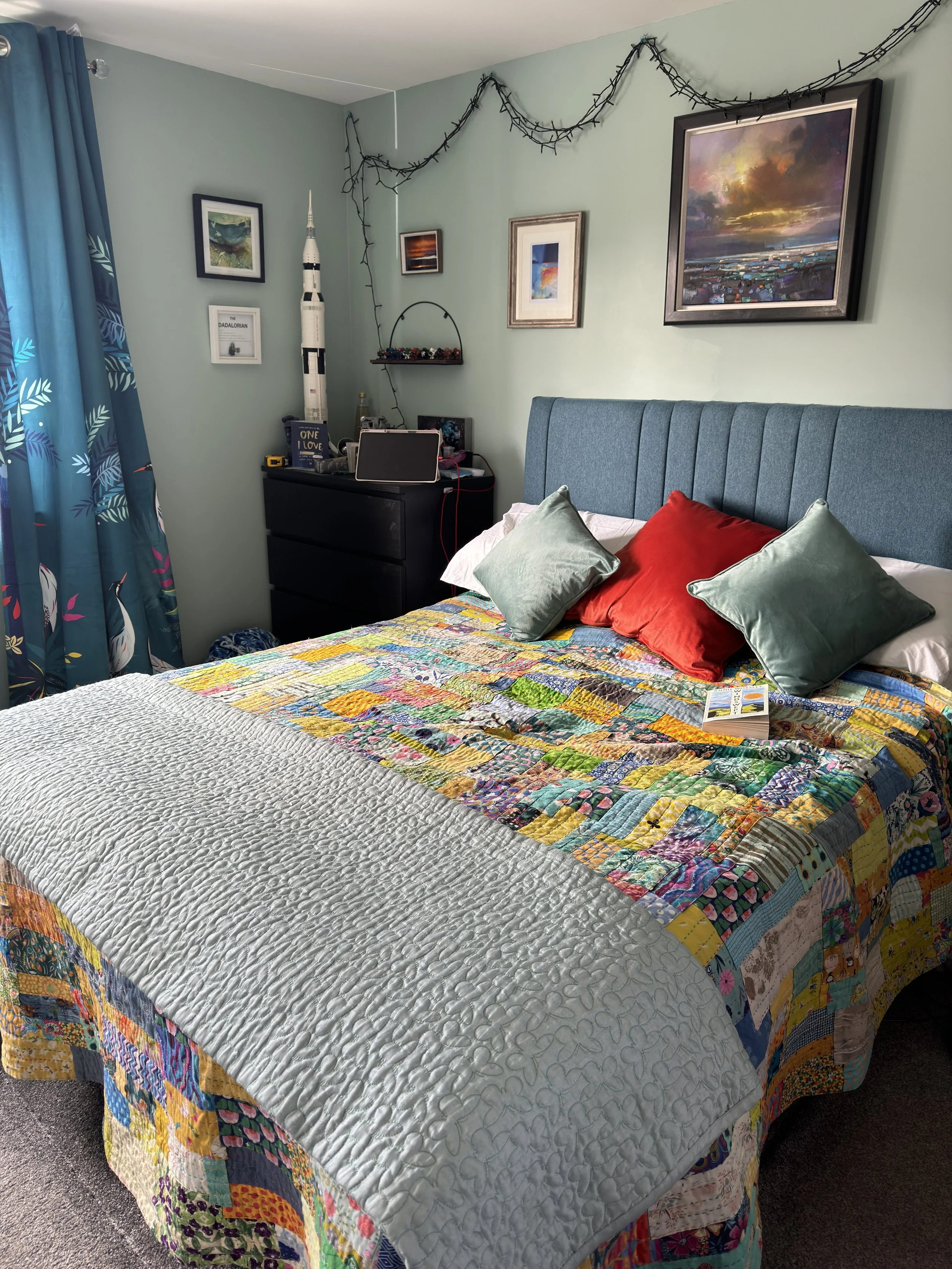 osy bedroom featuring handmade quilt and framed art