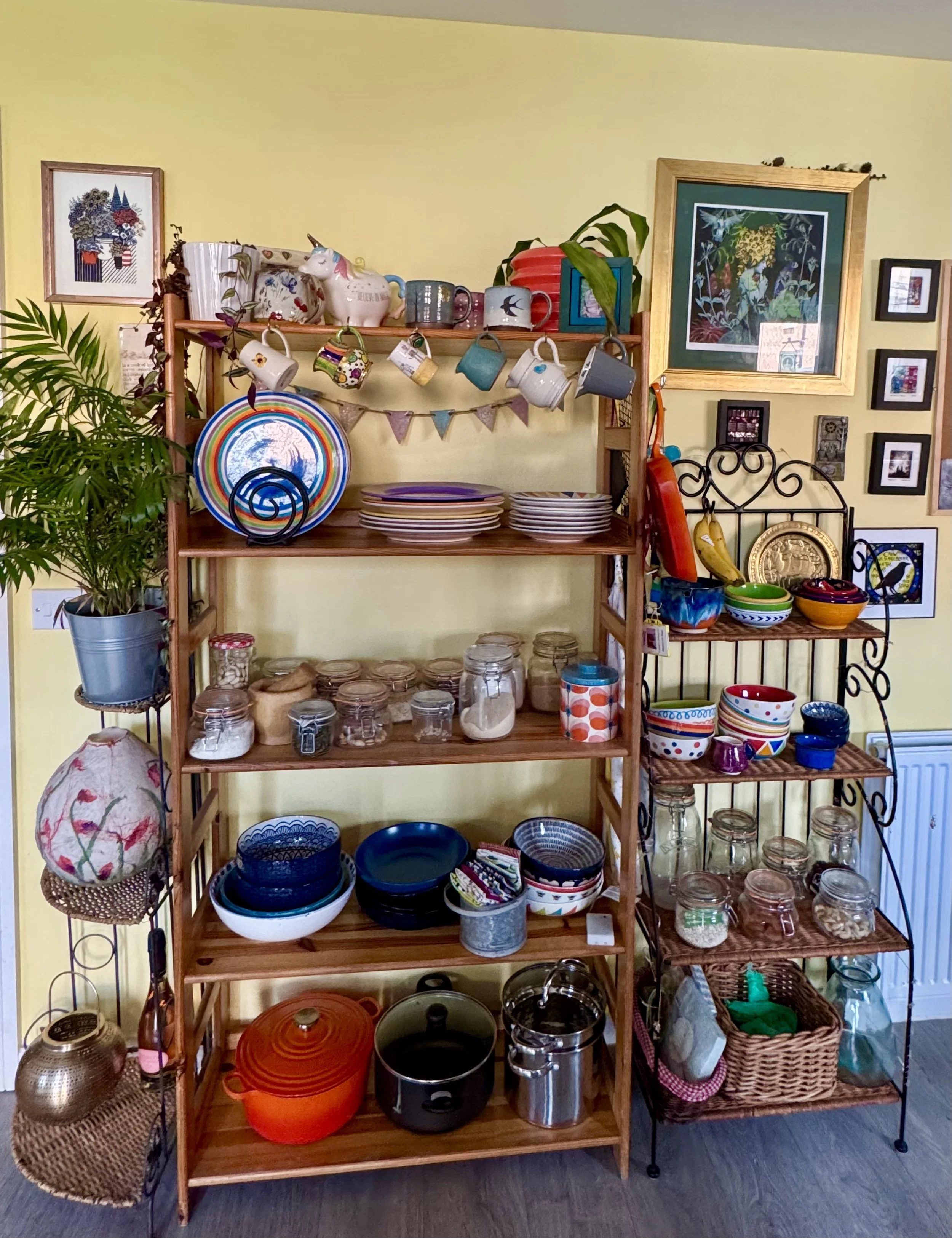 Kitchen shelves filled with colourful dishes, jars, pots, and eclectic decor.