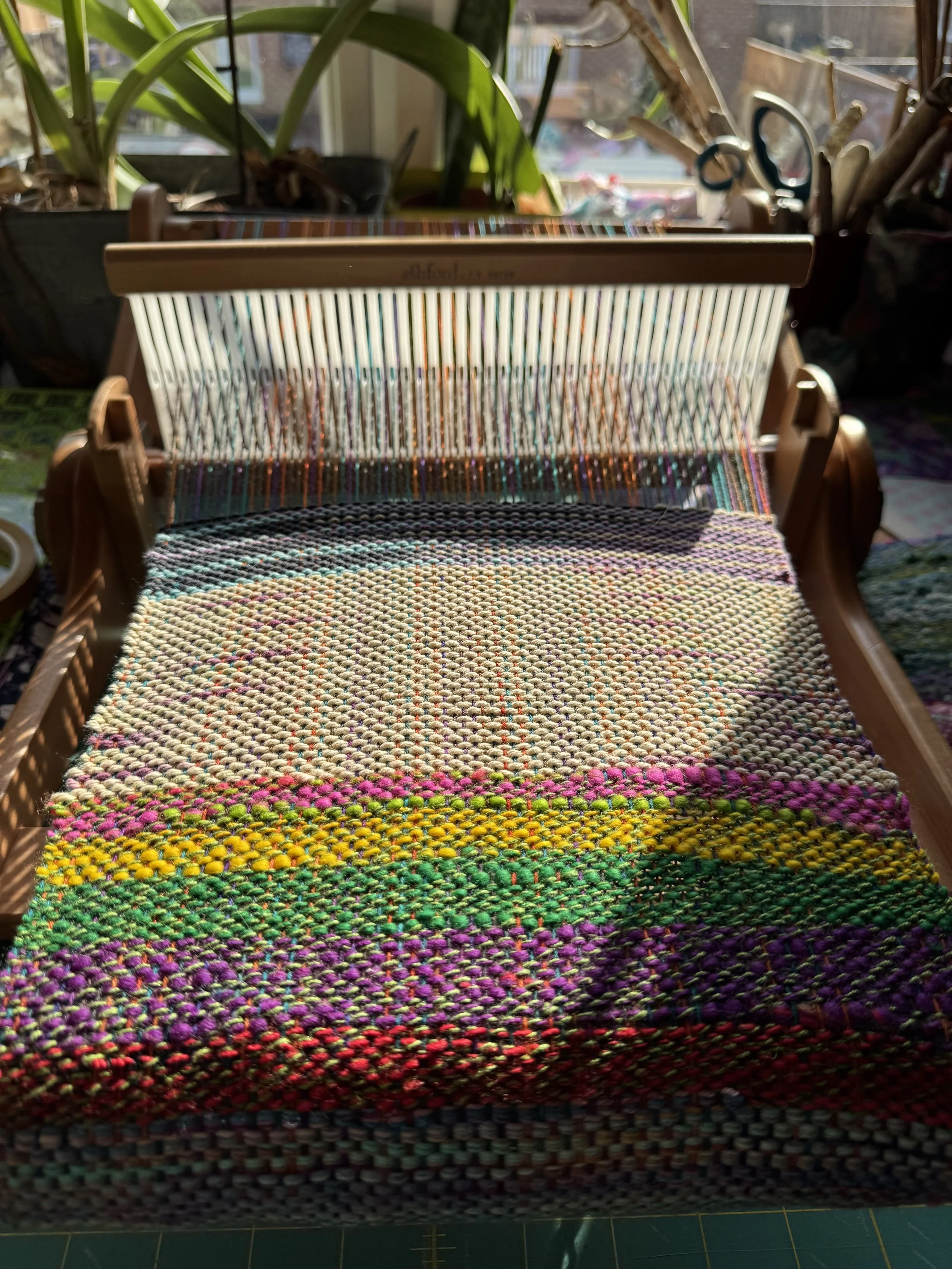 Weaving in progress, overhead shot, colourful