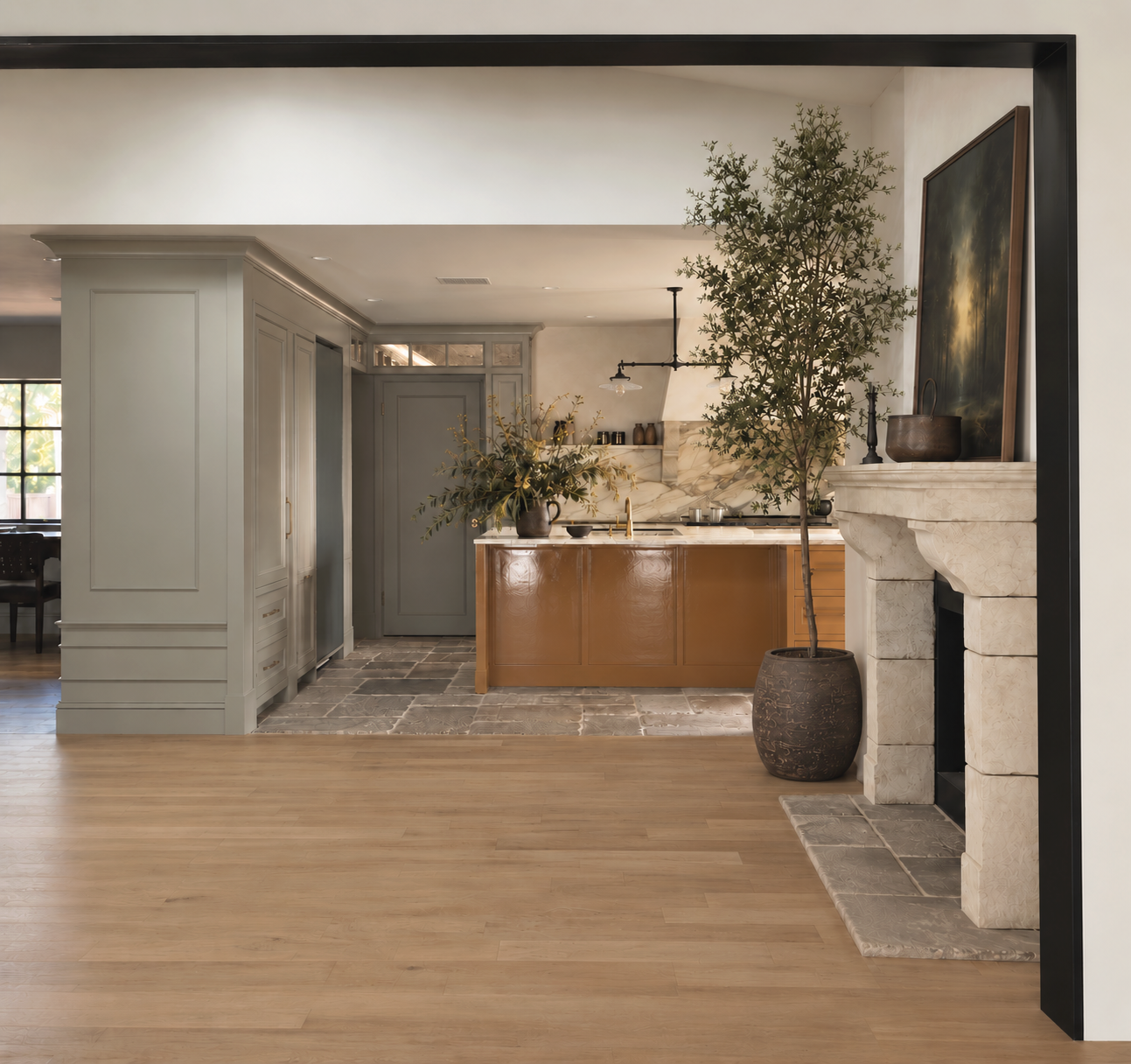 Maison in Hollywood kitchen and living room renovation with custom cabinetry, marble backsplash and stone fireplace.