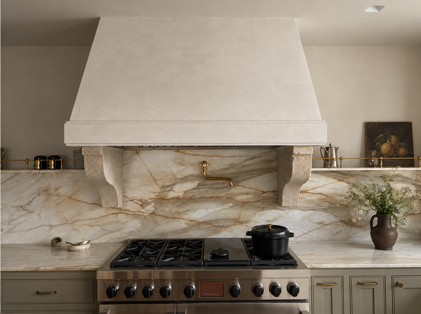 Custom kitchen at Maison in Hollywood with marble backsplash, plaster range hood and integrated cabinetry.