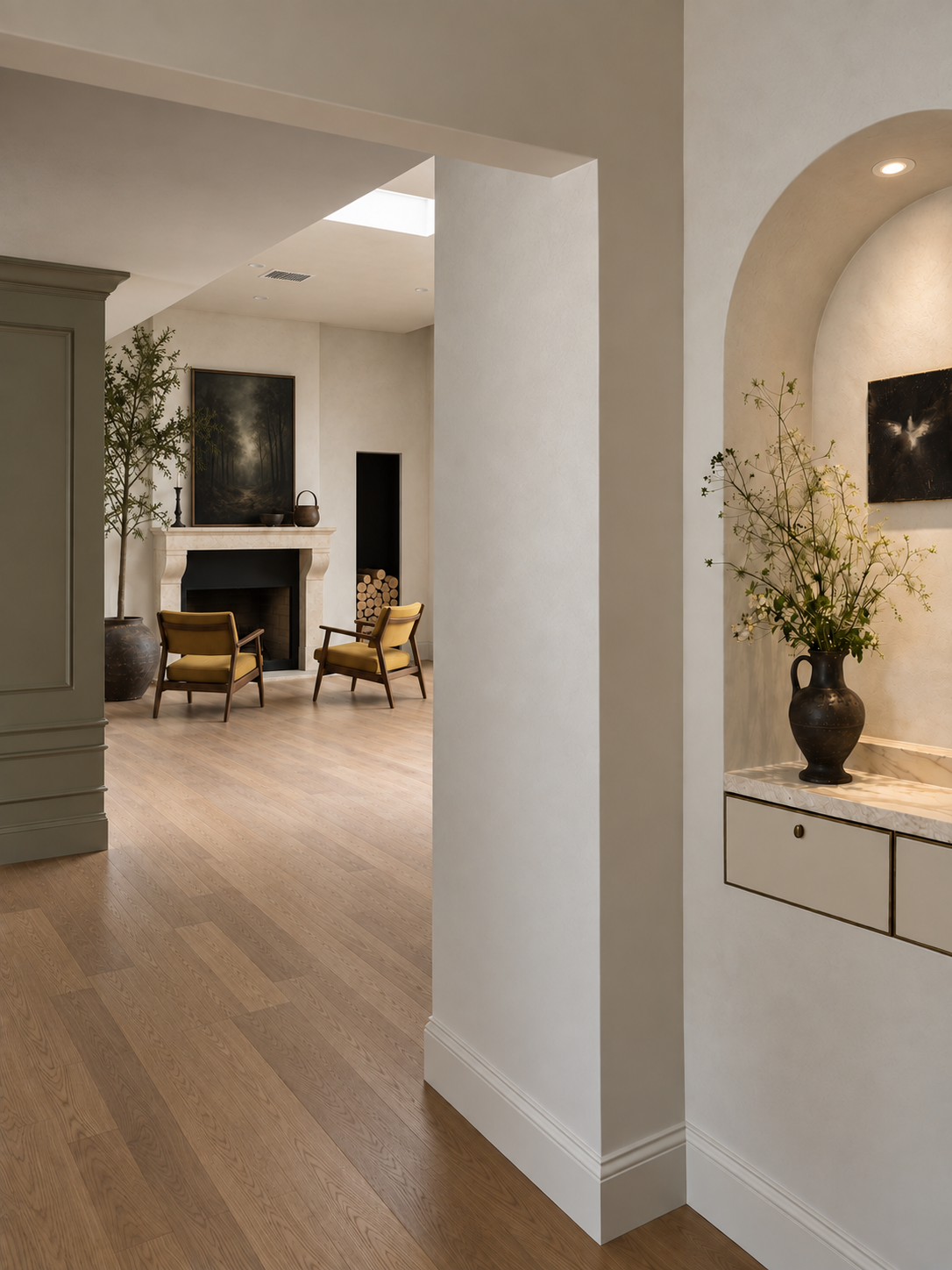 Maison in Hollywood living room with stone fireplace, integrated firewood niche and custom architectural detailing.