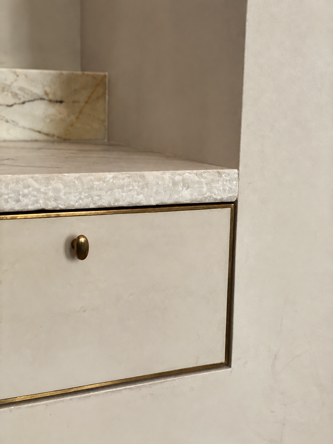 Detail of custom kitchen cabinetry at Maison in Hollywood with marble countertop and brass hardware.