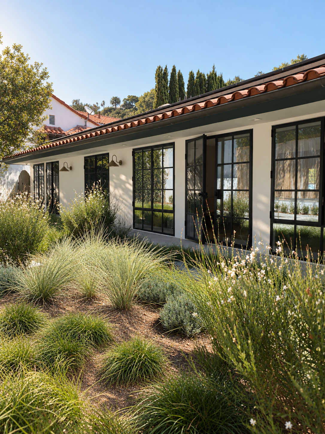 Maison in Hollywood residence in Nichols Canyon, Los Angeles, with black-framed Pinky's doors opening to the garden and surrounding natural landscape.