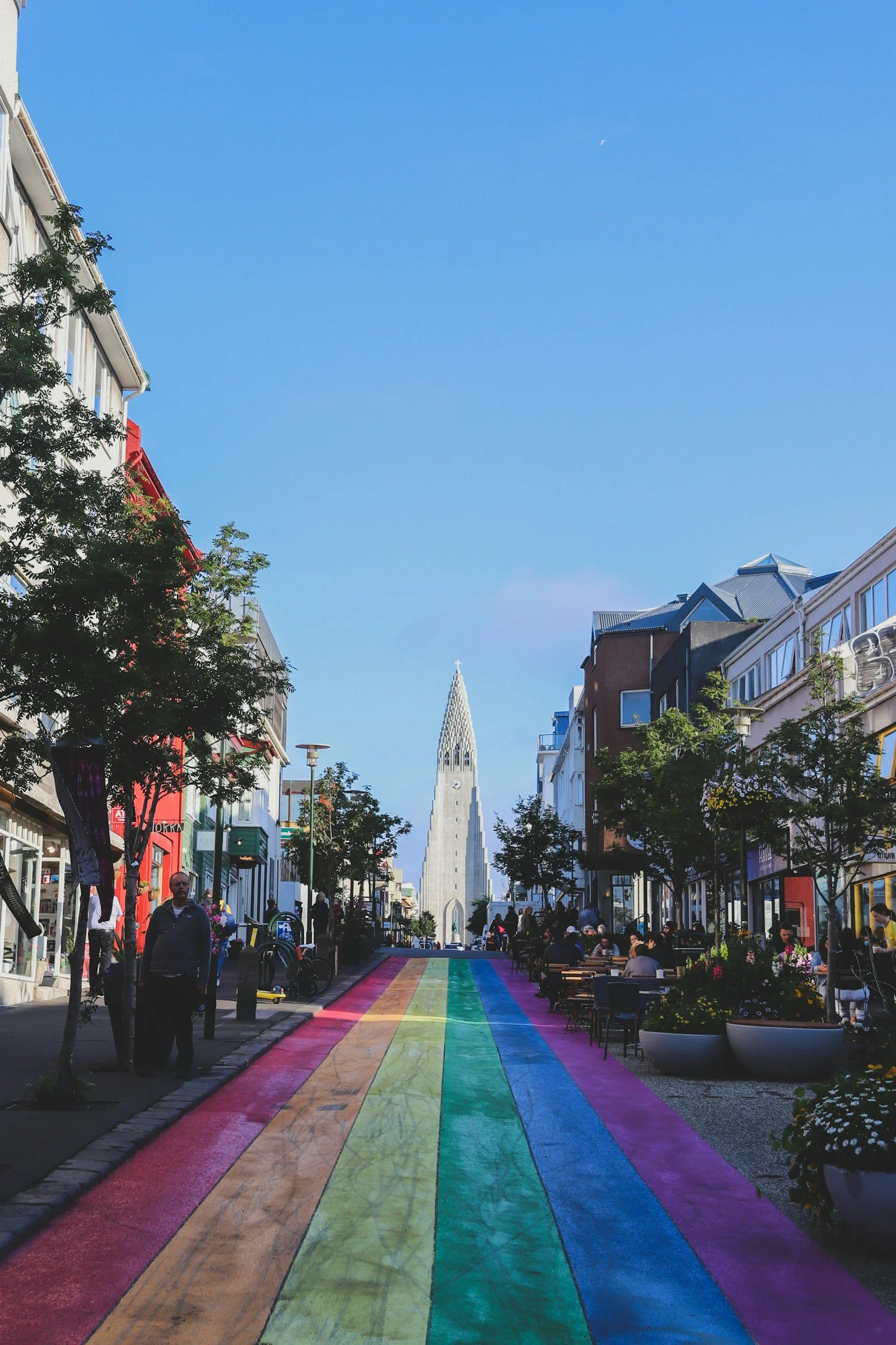 A church with a rainbow sidewalk leading to it