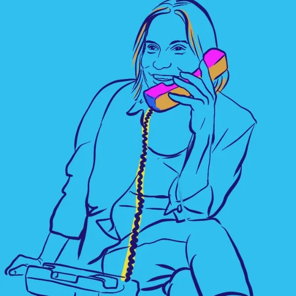 A happy woman speaking on a landline phone, she is so glad to be able to have her voice heard as a woman