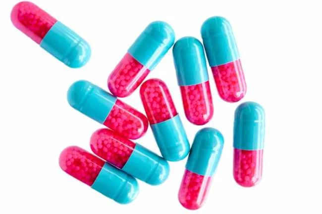 pink and blue pills on a white background, 19301