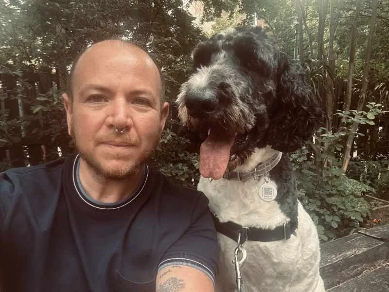 Eben selfie with panting black and white poodle