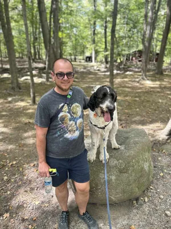 Eben with a fluffy black and white dog